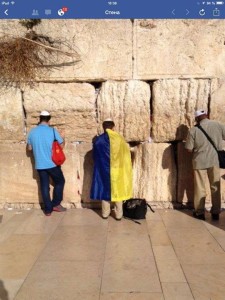 Man at Wailing Wall in Ukrainian Flag